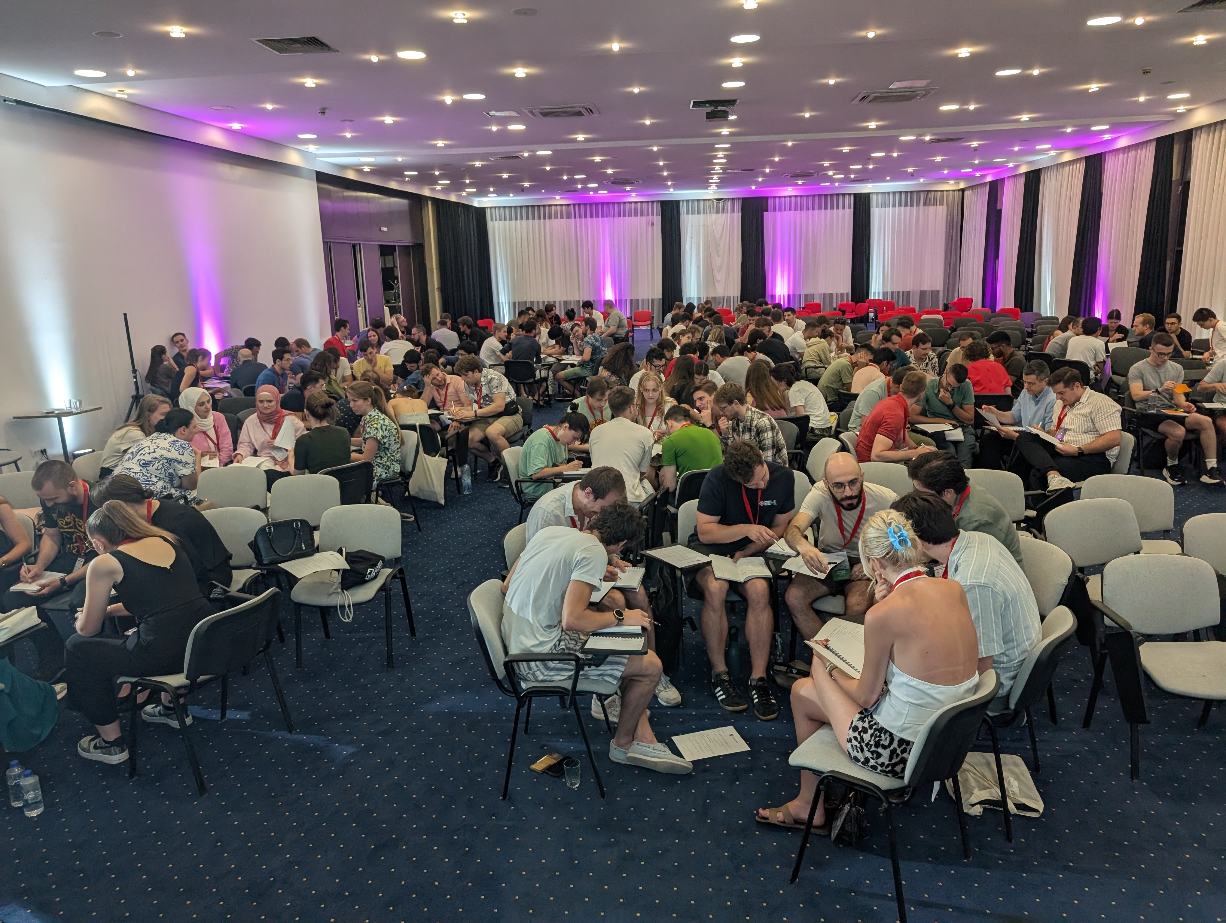 Participants collaborating in teams during the Jane Street Estimathon competition.