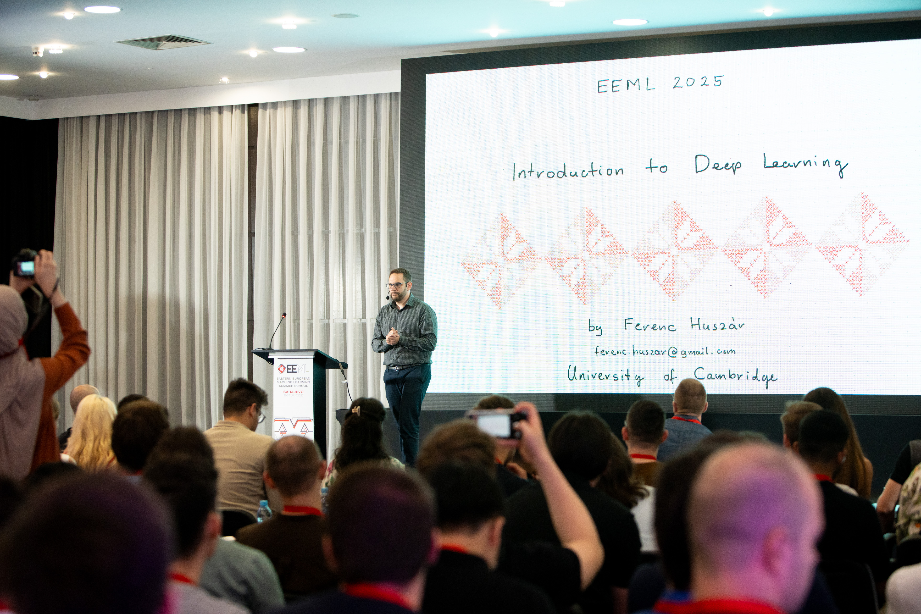 Speaker Ferenc Huszár giving his Intro to Deep Learning lecture to a full audience at EEML 2025.