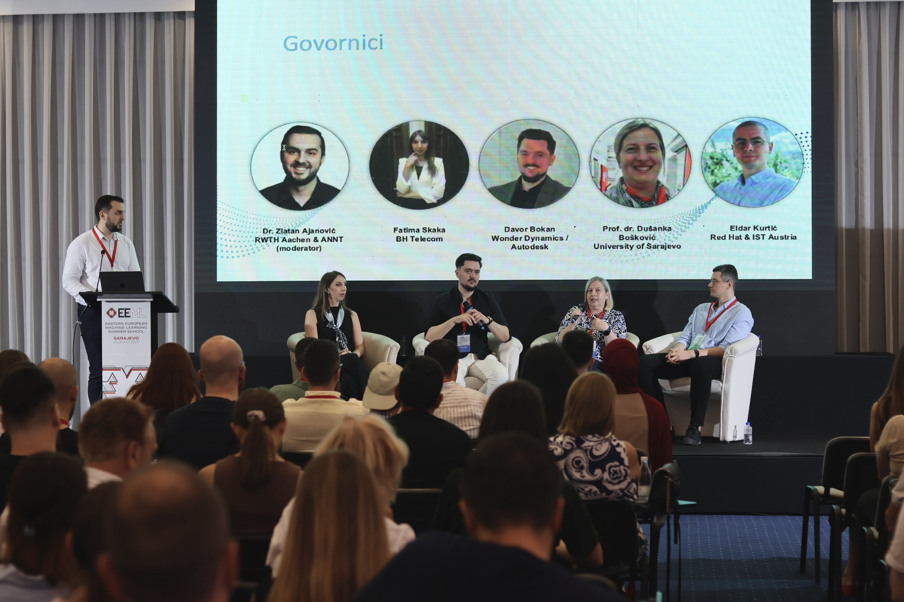 A panel of speakers on stage answering questions from the audience.