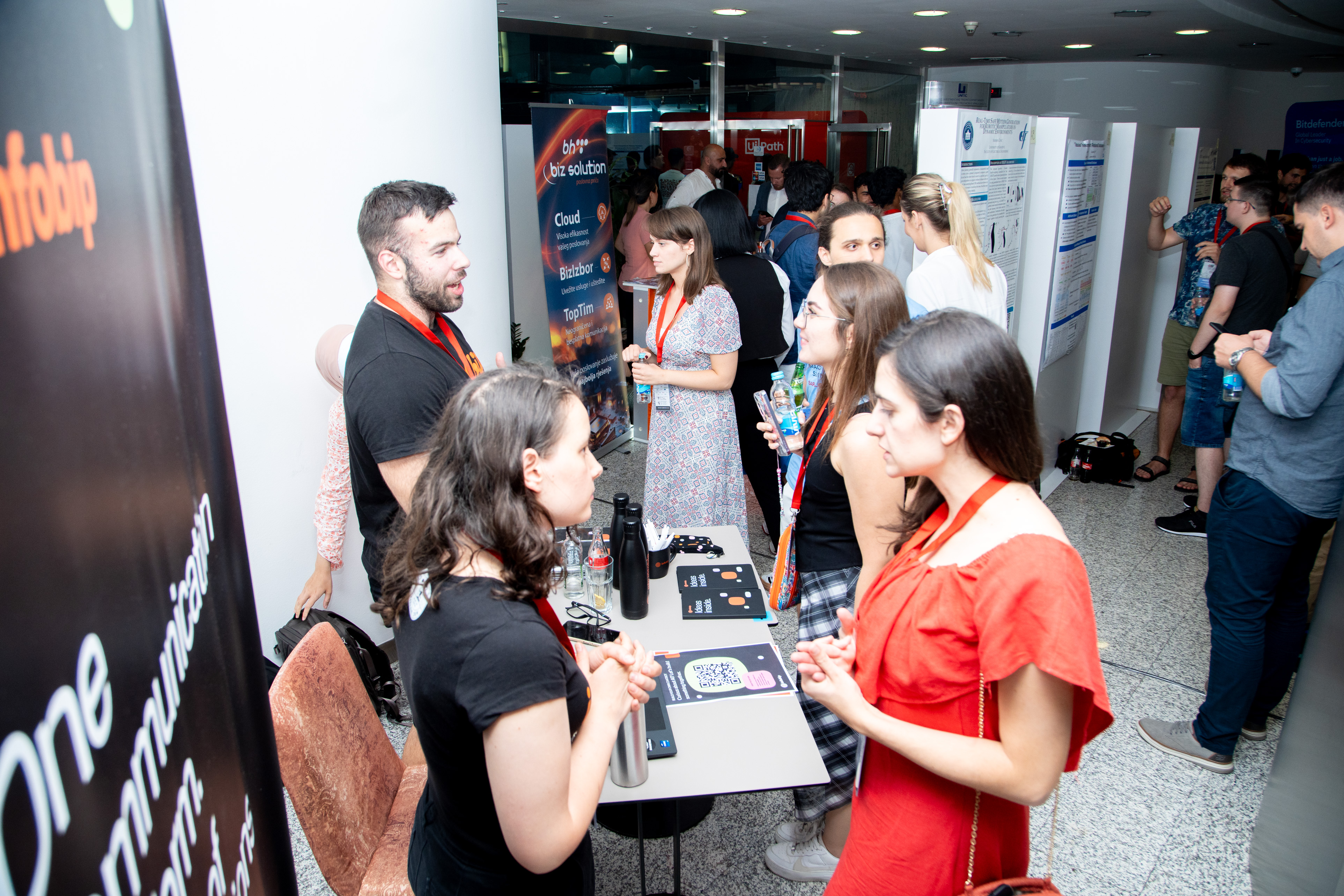 Attendees discussing research during the EEML 2025 poster session.