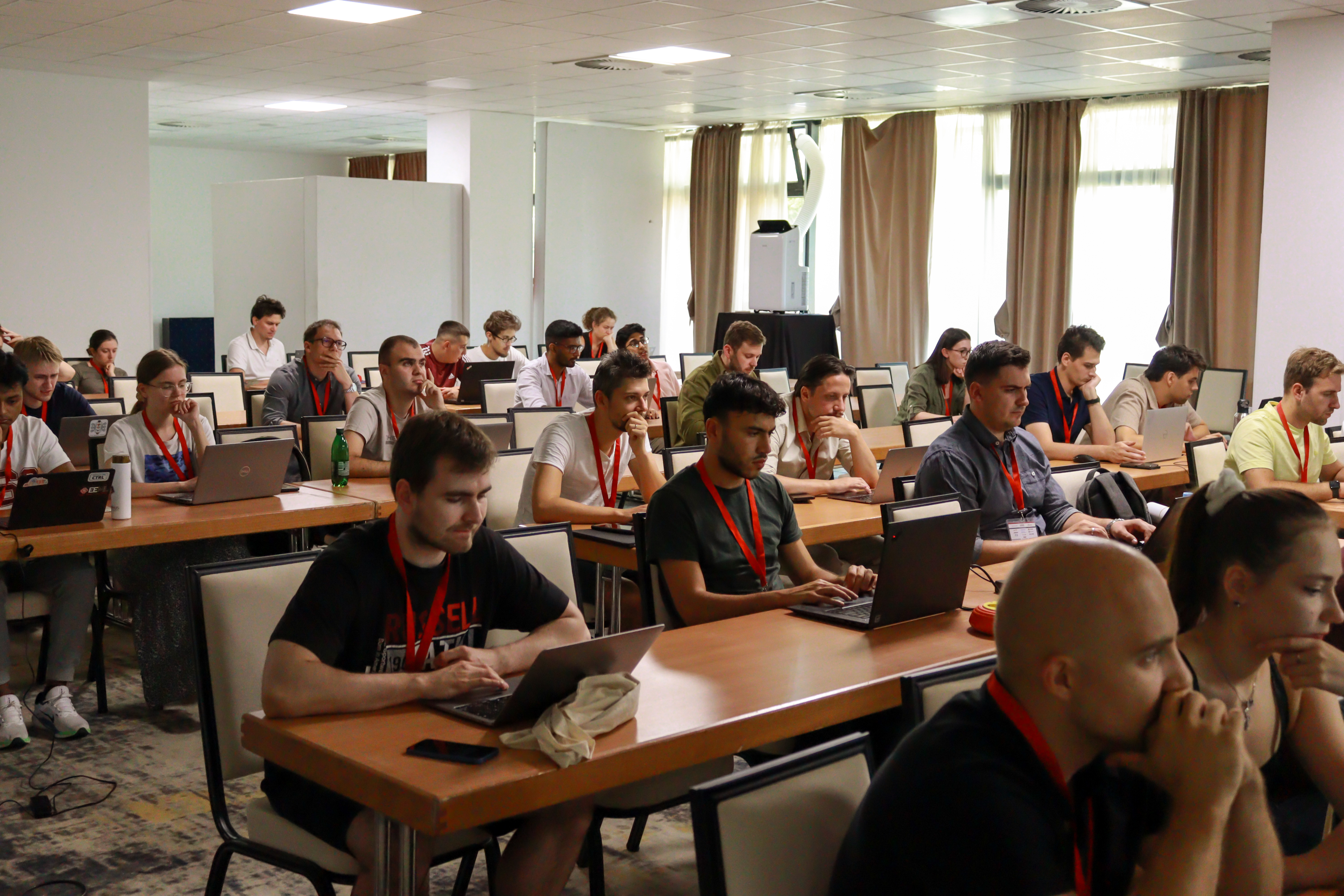 Participants working on their laptops during a hands-on tutorial session.
